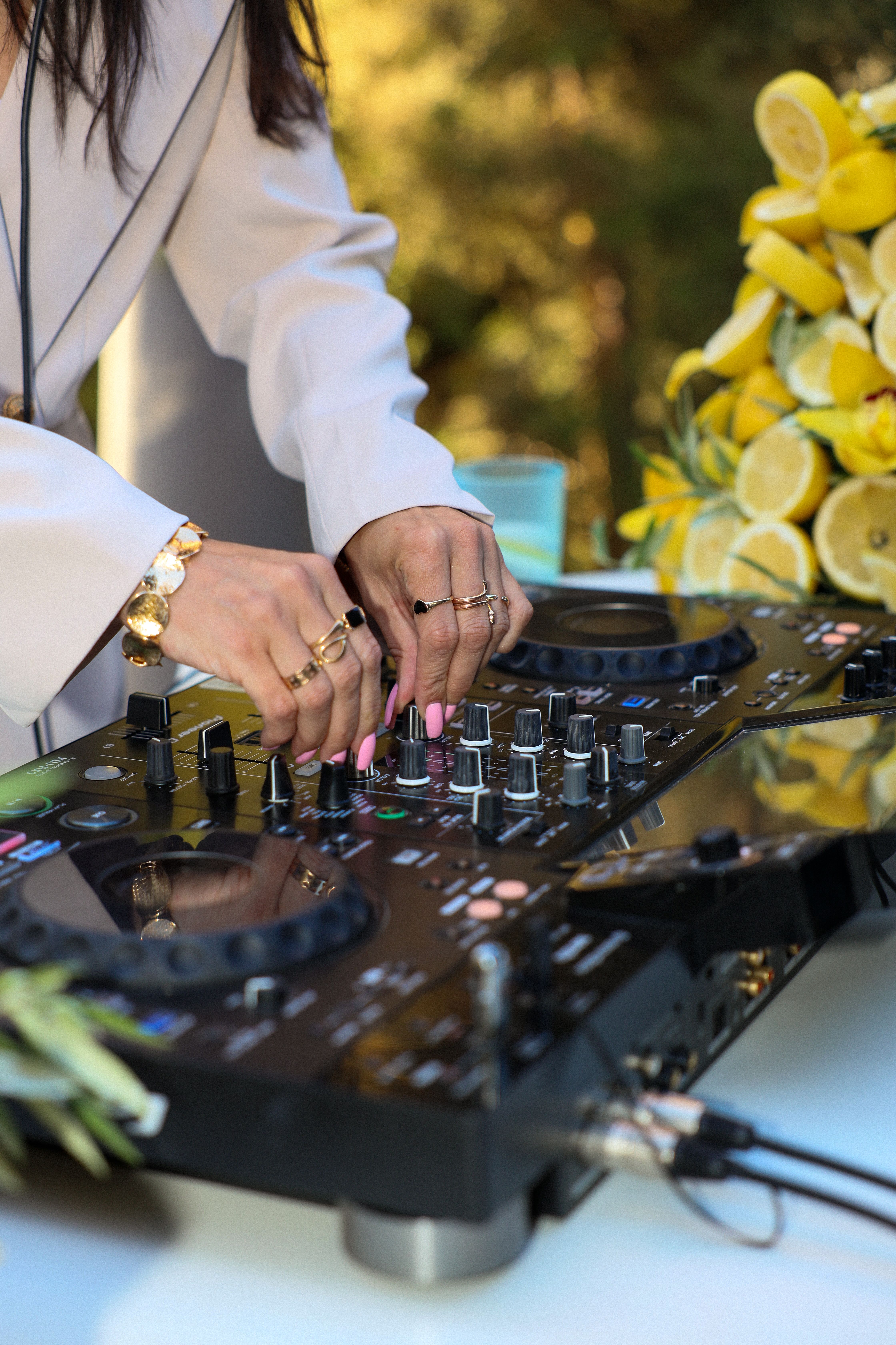 DJ playing a set beside a display of fresh lemons