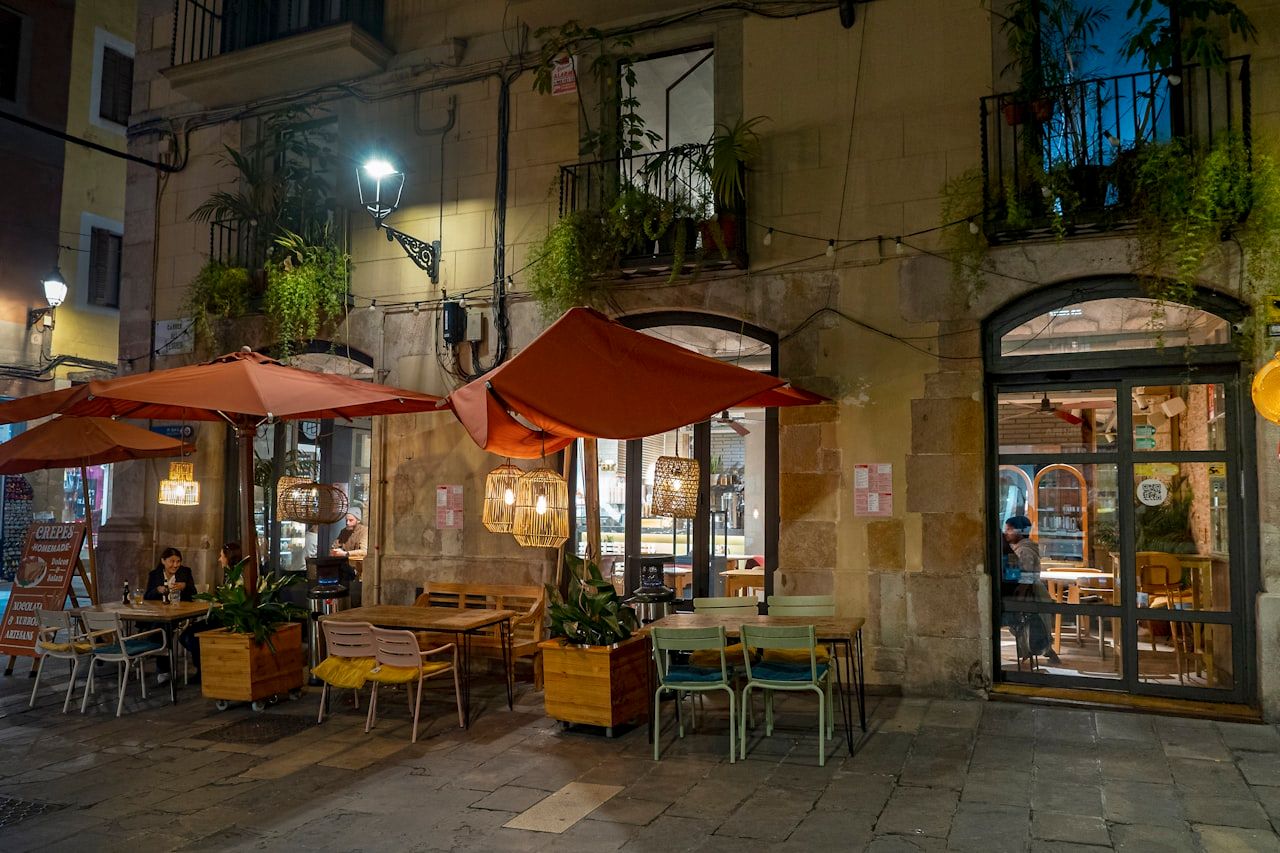Outdoor Mediterranean restaurant and bar with warm evening lights