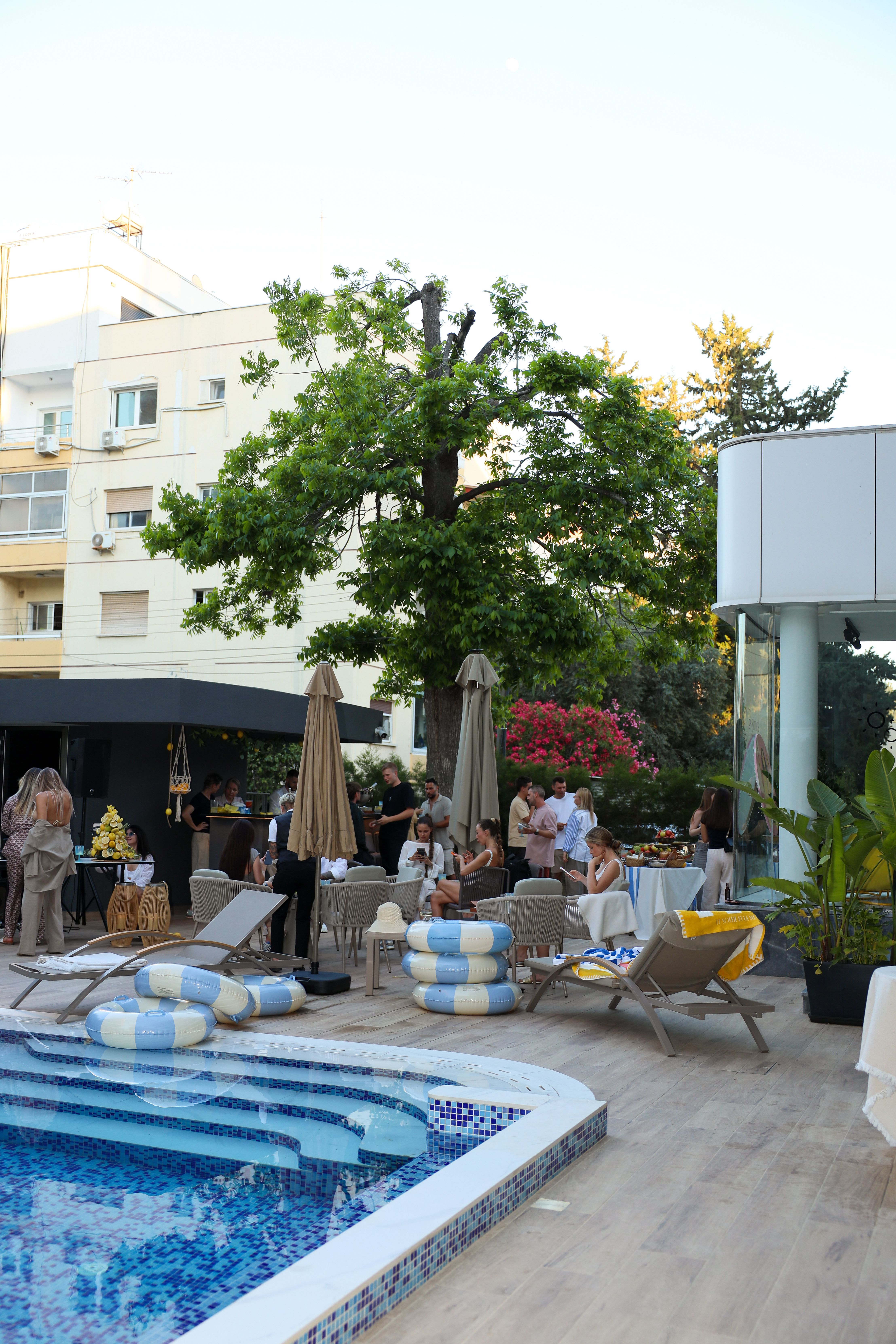 Poolside event in full swing under the garden tree