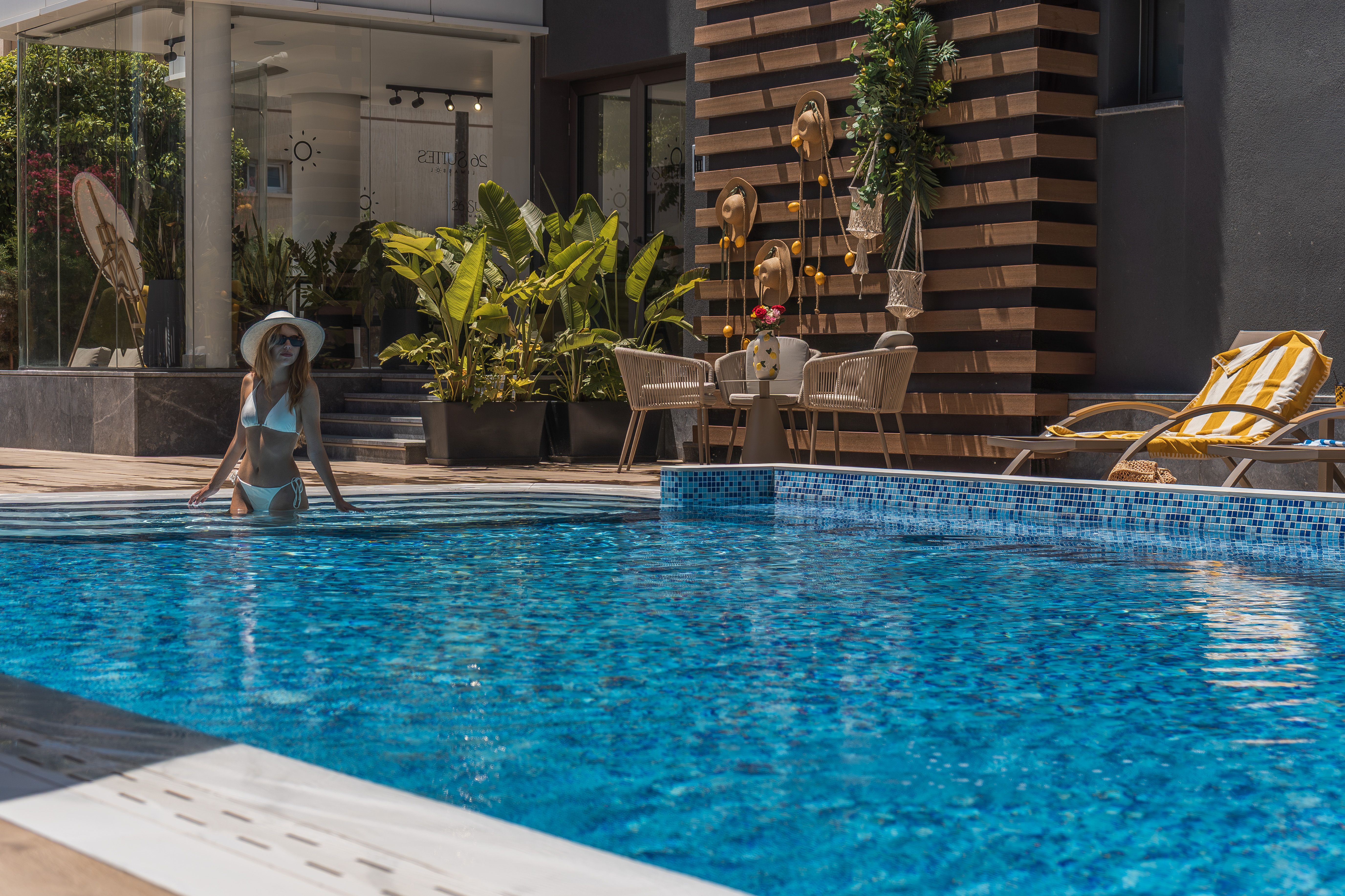 Guest in the pool by the 26 Suites entrance